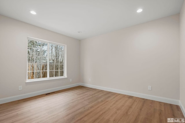 unfurnished room featuring light hardwood / wood-style floors