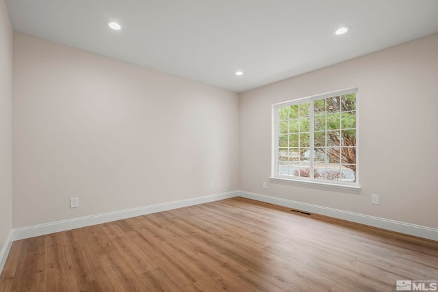 empty room with light hardwood / wood-style floors