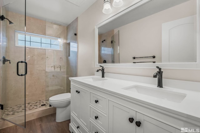 bathroom with vanity, toilet, wood-type flooring, and walk in shower