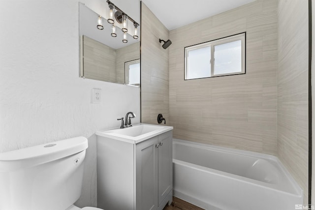 full bathroom featuring vanity, toilet, and tiled shower / bath combo