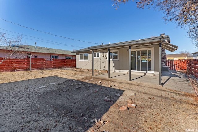 rear view of house featuring a patio and central AC unit