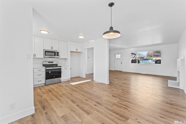 kitchen featuring light hardwood / wood-style floors, white cabinets, pendant lighting, and appliances with stainless steel finishes