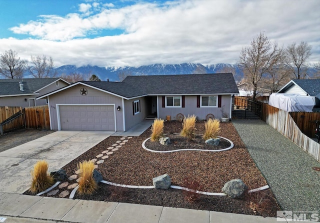 single story home featuring a mountain view and a garage