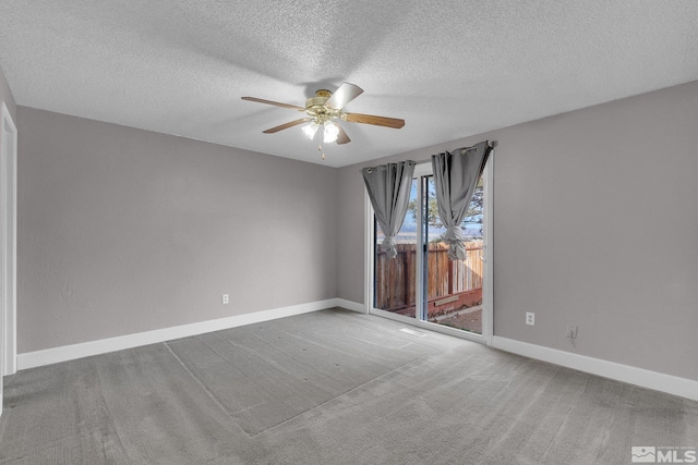 carpeted empty room featuring a textured ceiling and ceiling fan