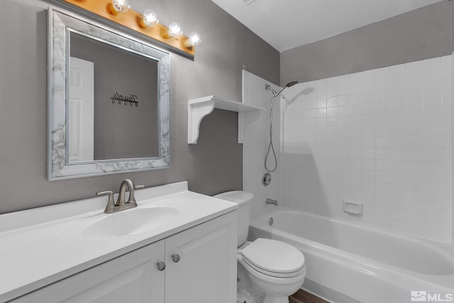 full bathroom featuring toilet, vanity, and washtub / shower combination