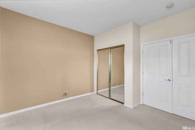 unfurnished bedroom featuring light colored carpet