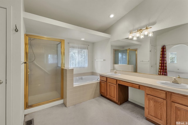 bathroom with vanity, vaulted ceiling, and separate shower and tub