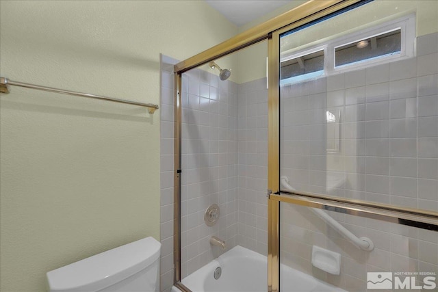 bathroom featuring toilet and enclosed tub / shower combo