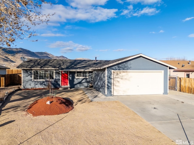 single story home with a mountain view and a garage