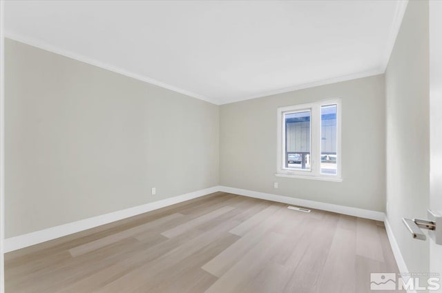 unfurnished room with light wood-type flooring and ornamental molding