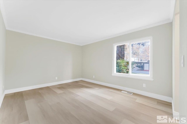 unfurnished room with crown molding and light wood-type flooring