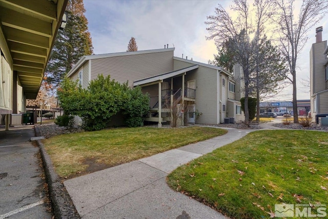 exterior space featuring a lawn and cooling unit