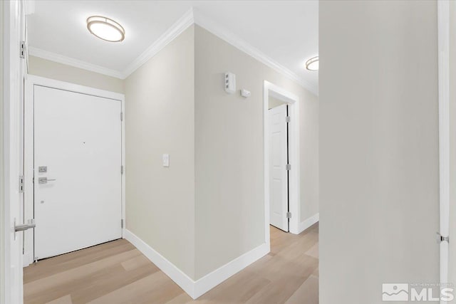 entrance foyer with light hardwood / wood-style flooring and crown molding