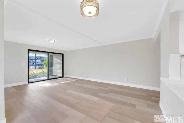 spare room with light hardwood / wood-style flooring and ornamental molding