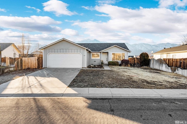 ranch-style home featuring a mountain view and a garage