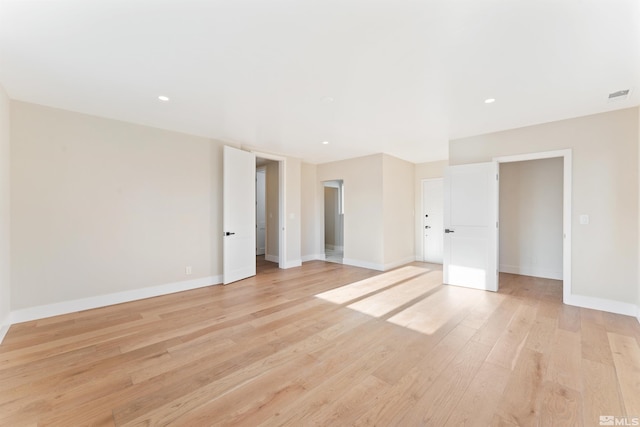 unfurnished room with light wood-type flooring