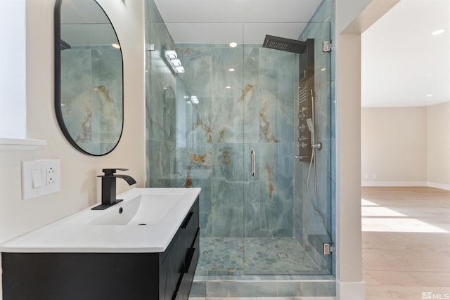 bathroom with hardwood / wood-style flooring, vanity, and an enclosed shower