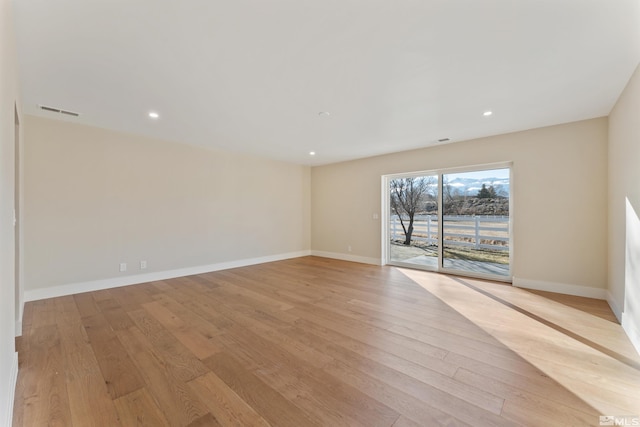 spare room with light hardwood / wood-style floors