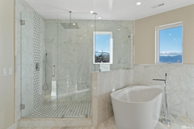 bathroom featuring separate shower and tub