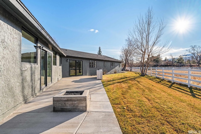 view of yard with an outdoor fire pit and a patio