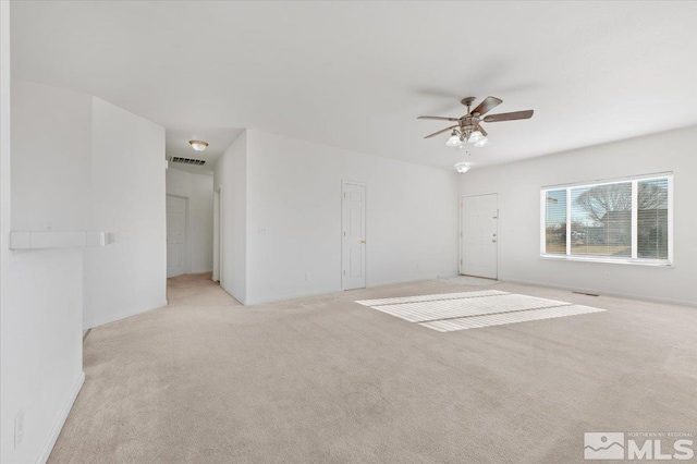 spare room with ceiling fan and light colored carpet