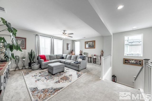 living room featuring ceiling fan and light colored carpet