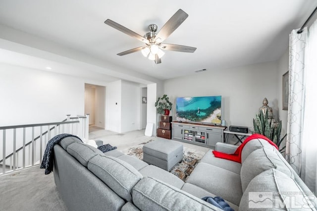 carpeted living room with ceiling fan