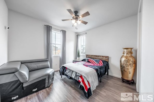 bedroom with hardwood / wood-style flooring and ceiling fan