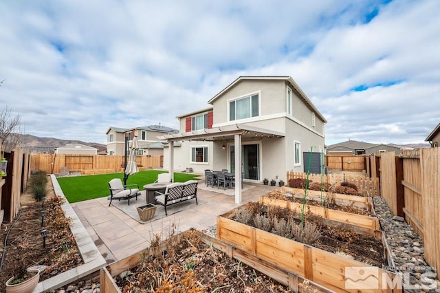 rear view of house featuring a patio area and a lawn