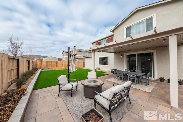 view of patio featuring an outdoor living space with a fire pit