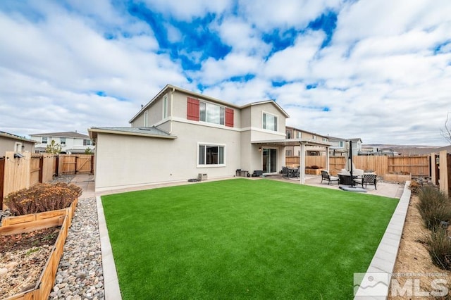 back of house with a lawn and a patio area