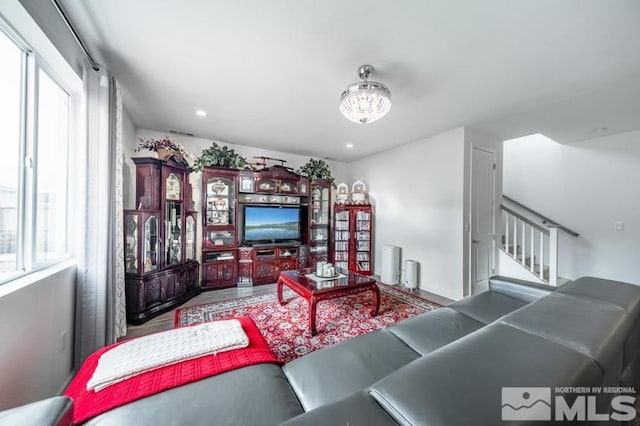 living room with plenty of natural light and a chandelier