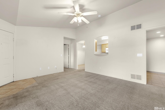 unfurnished room featuring ceiling fan, light tile patterned flooring, and high vaulted ceiling