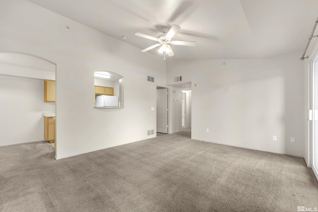 carpeted empty room with ceiling fan and lofted ceiling