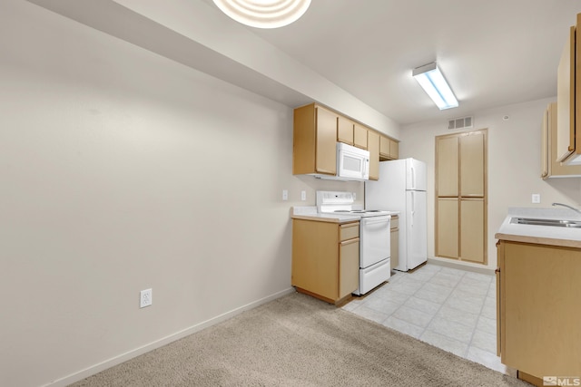 kitchen with light colored carpet, white appliances, and sink