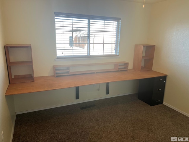 unfurnished office with dark colored carpet