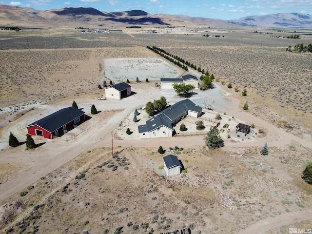 birds eye view of property with a mountain view and a rural view