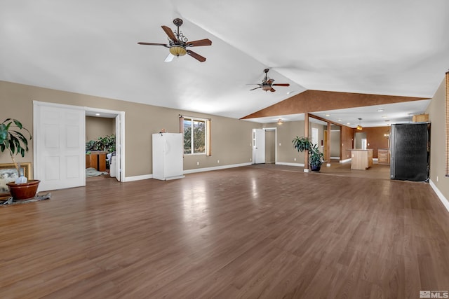 unfurnished living room with lofted ceiling, ceiling fan, and dark wood-type flooring