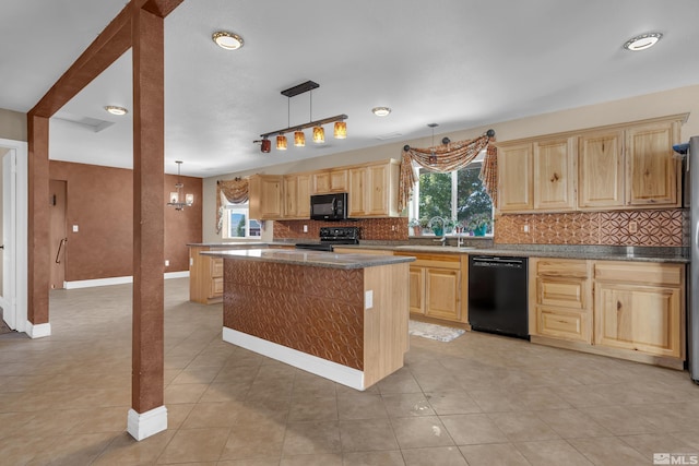 kitchen with sink, black appliances, a notable chandelier, a kitchen island, and hanging light fixtures