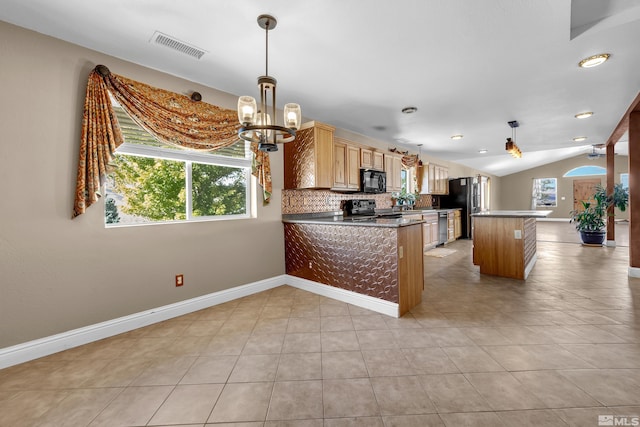 kitchen featuring stainless steel appliances, kitchen peninsula, pendant lighting, vaulted ceiling, and decorative backsplash