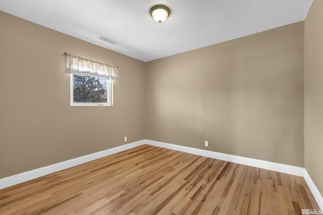 spare room featuring light wood-type flooring