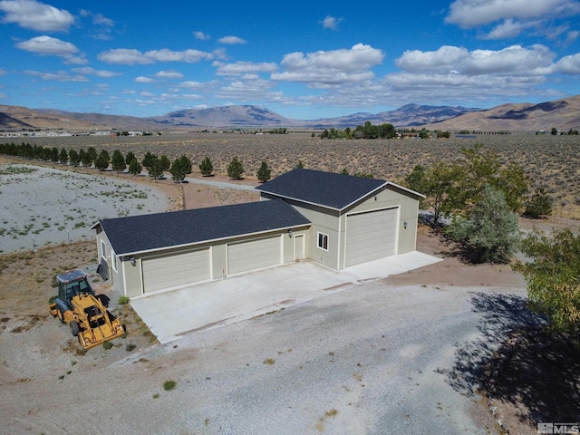 view of front facade with a mountain view and a garage