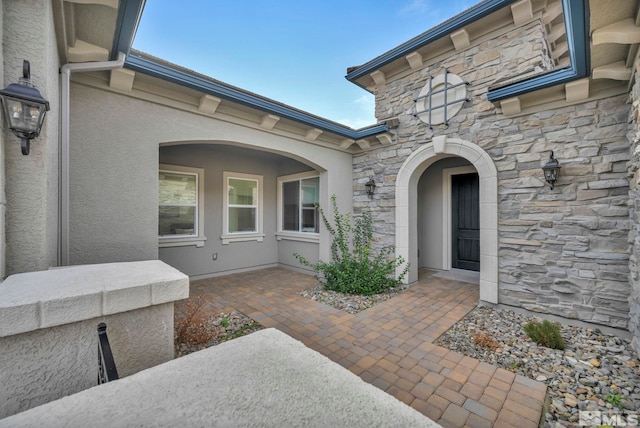 entrance to property featuring a patio area