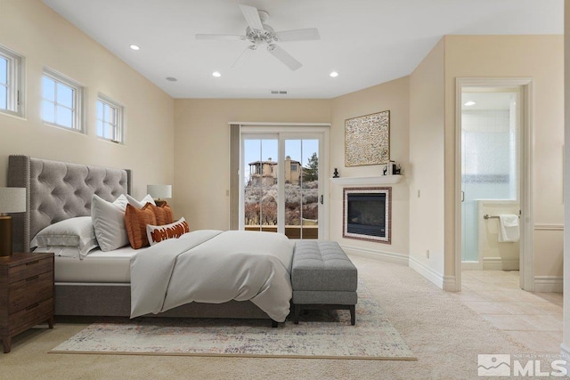 carpeted bedroom with connected bathroom and ceiling fan