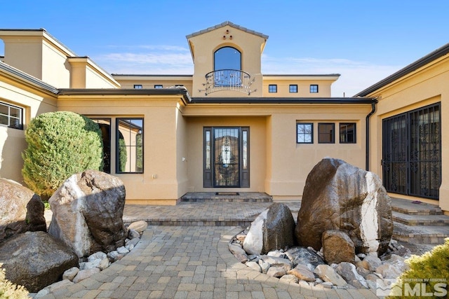 entrance to property featuring a balcony