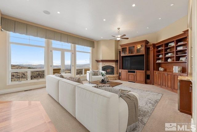 living room featuring light colored carpet and ceiling fan