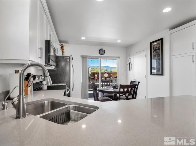 kitchen featuring sink and white cabinets