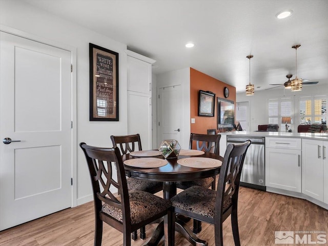 dining space featuring ceiling fan and light wood-type flooring