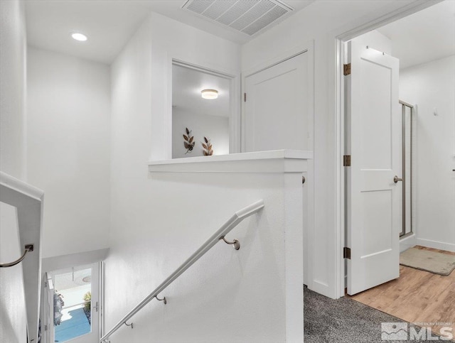 staircase with hardwood / wood-style flooring