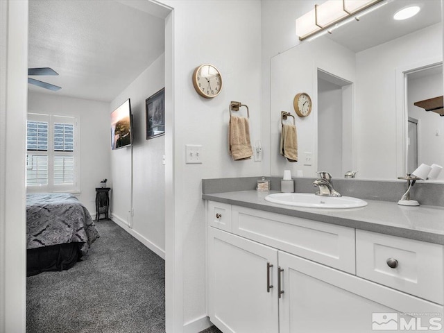 bathroom featuring ceiling fan and vanity